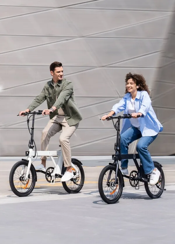couple riding stylish foldable electric bikes.